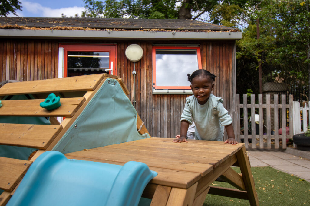 Child on the slide at LEYF Gumboots Nursery