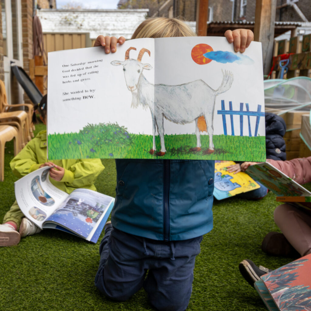 Micky Star Nursery child holding up book