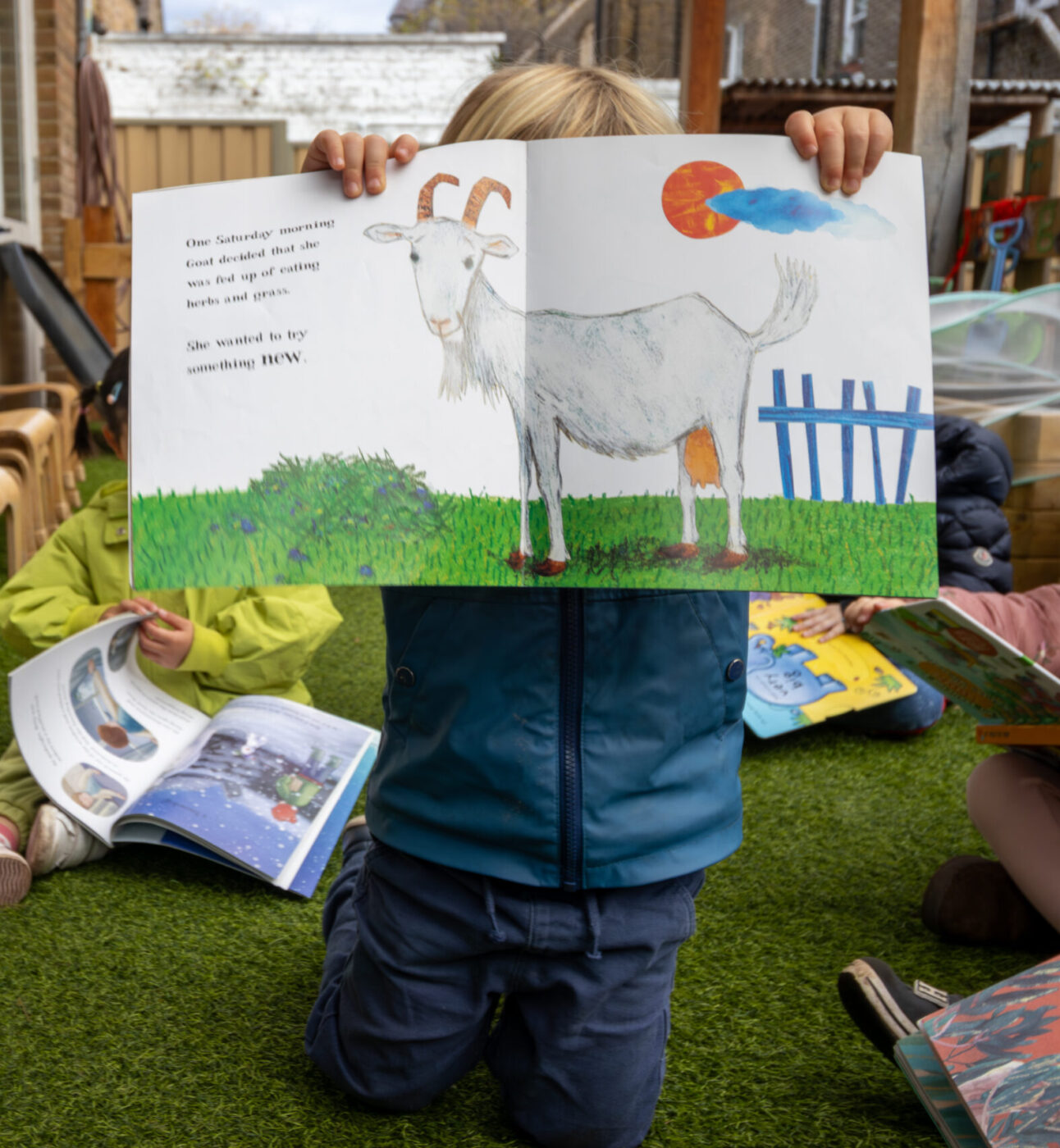 Micky Star Nursery child holding up book