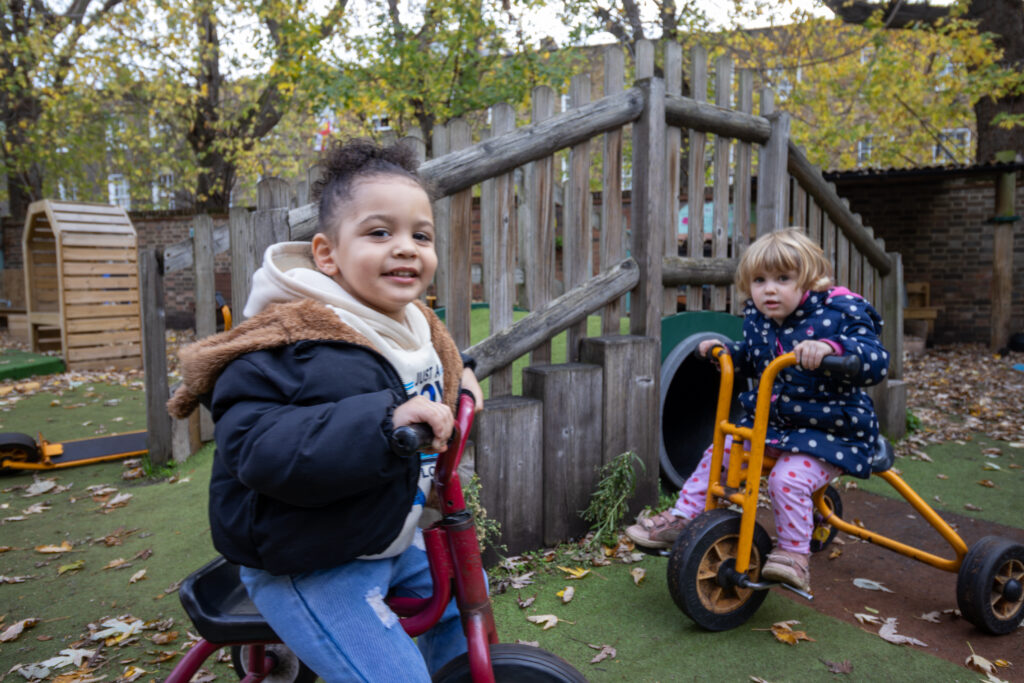 Two children playing on bikes at LEYF Micky Star