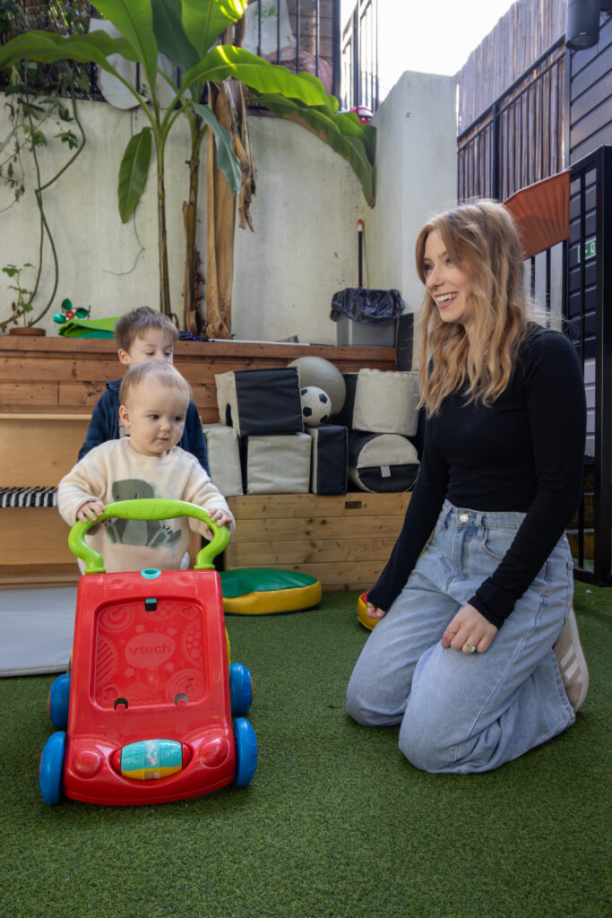 Playing with a pram at LEYF Noah's Ark Nursery