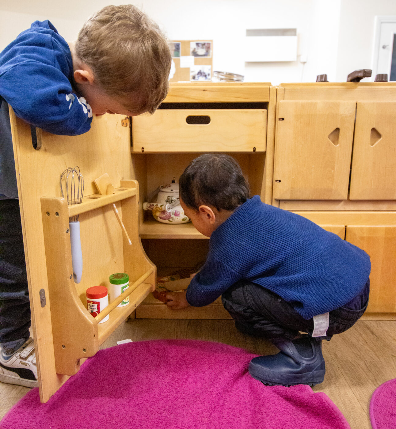 Children of Marks Gate Nursery playing in a cupboard