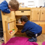 Children of Marks Gate Nursery playing in a cupboard