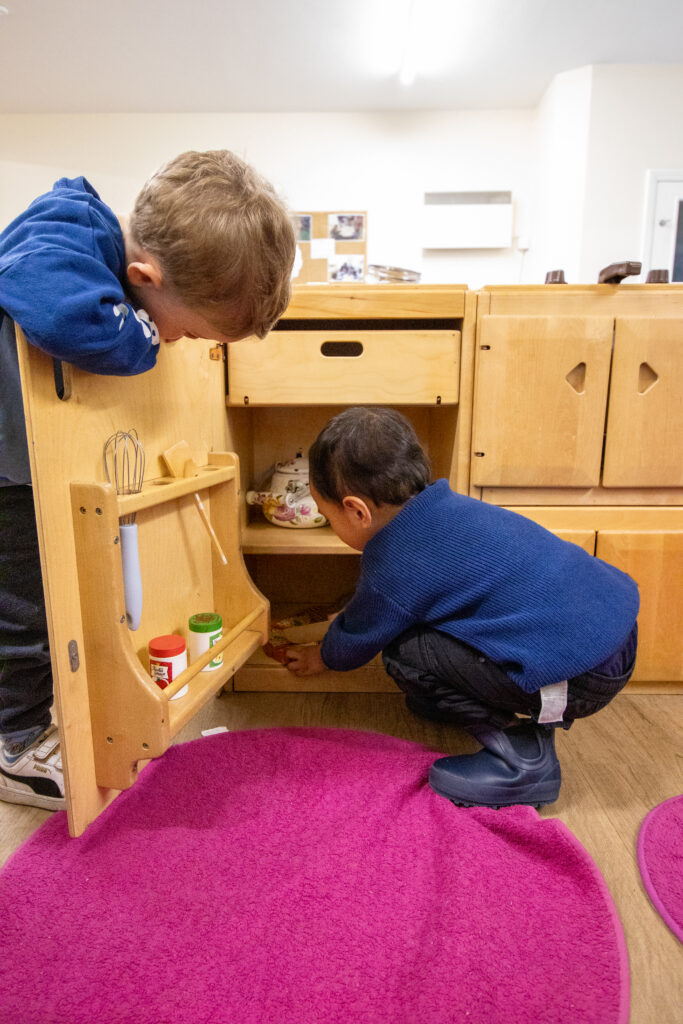 Children of Marks Gate Nursery playing in a cupboard