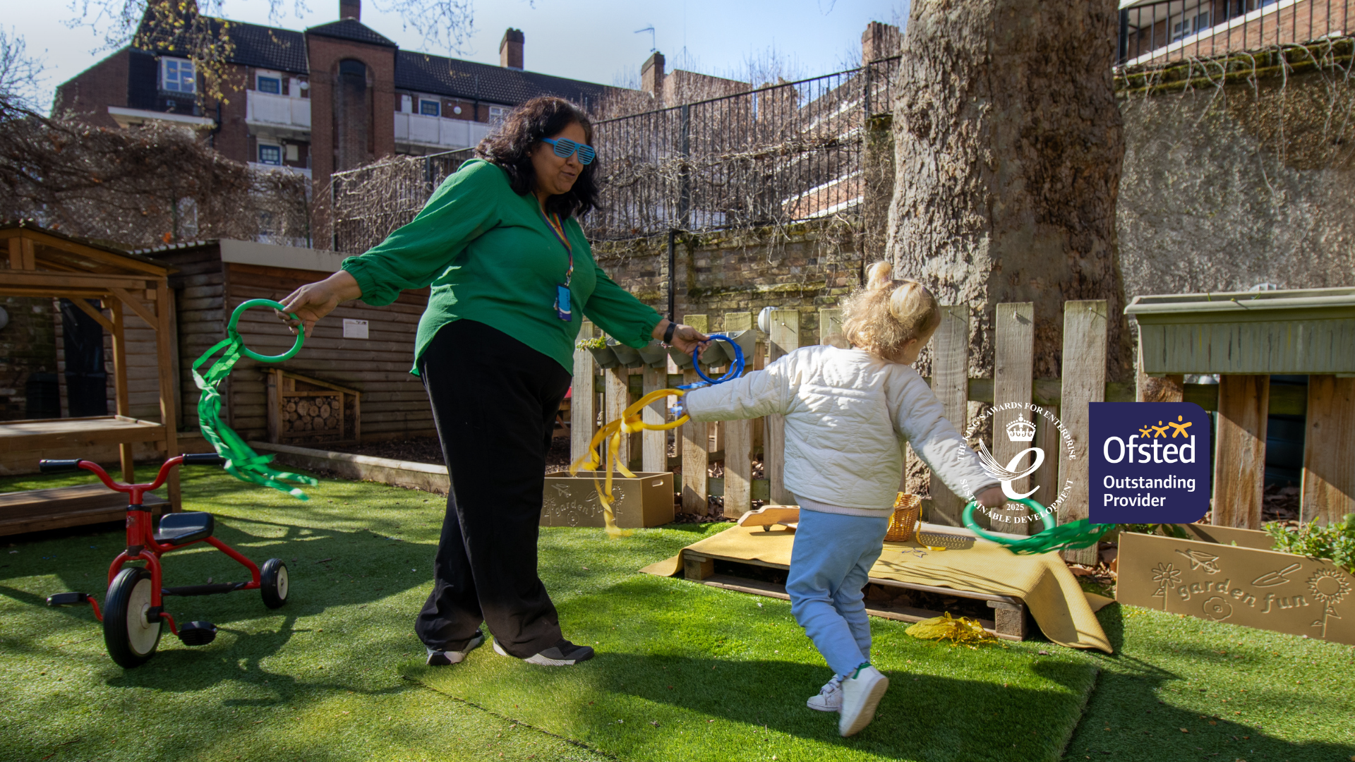 LEYF teacher playing with child in the garden. For LEYF Homepage banner.